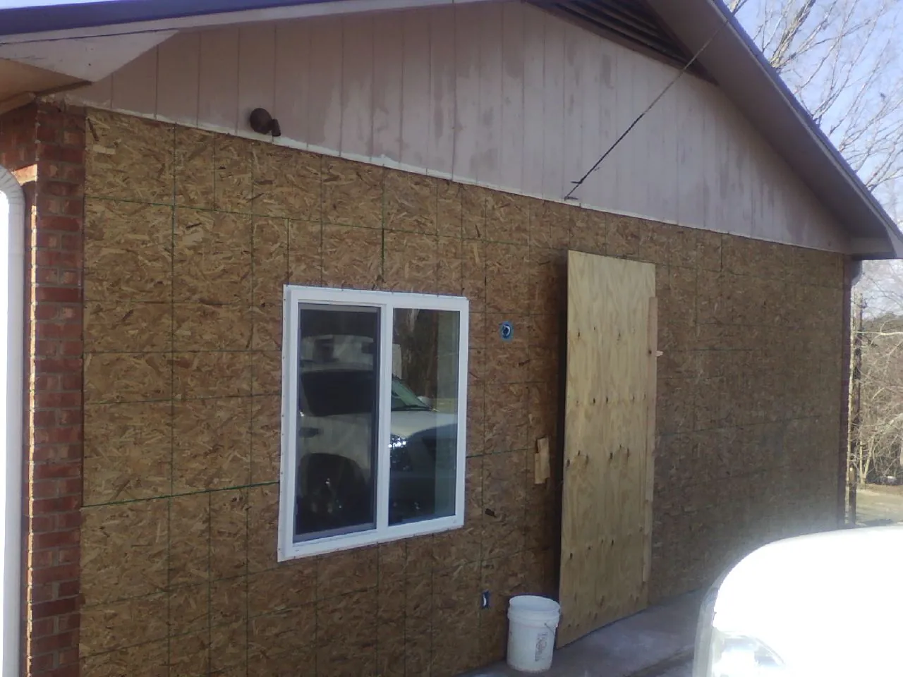 OSB sheathing on a garage addition wall before siding in Ellsworth